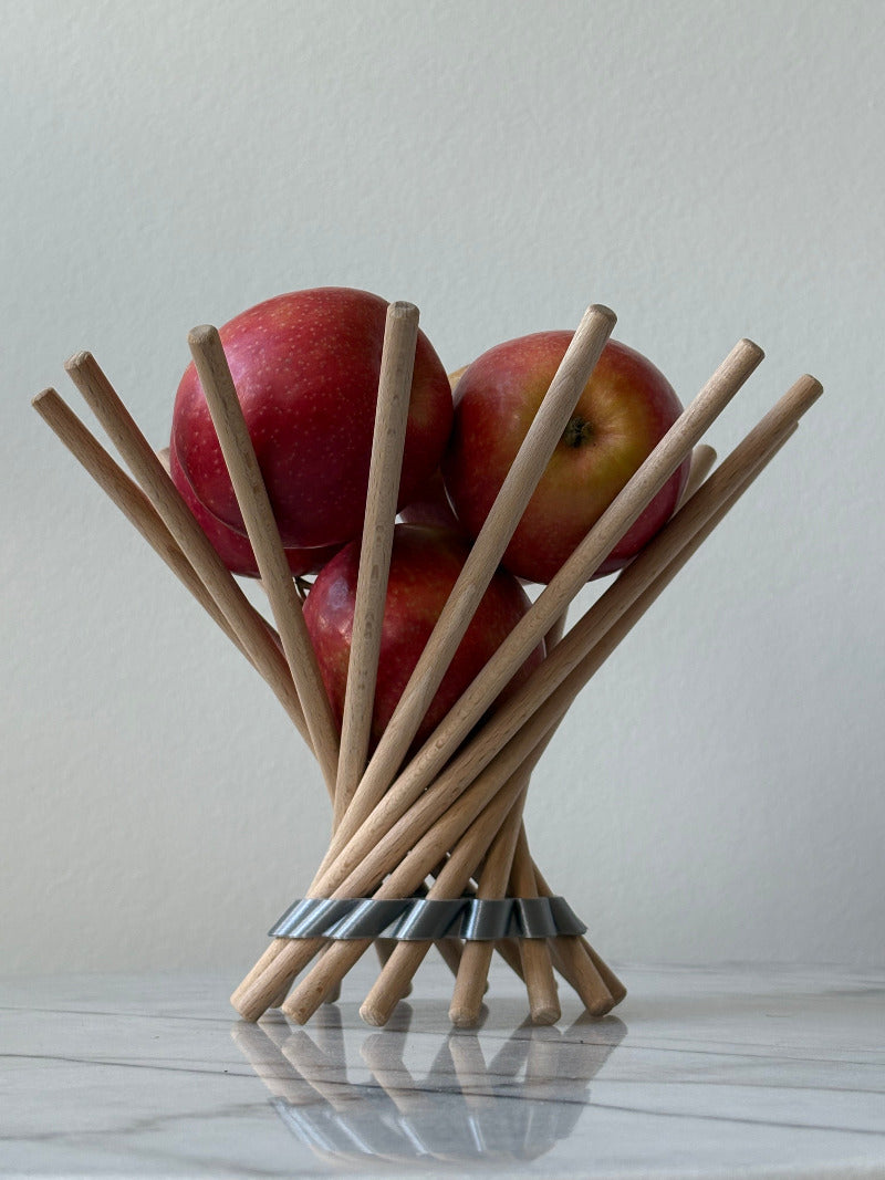 mit Obst gefüllte Obstschale Dekoschale steckbare Schale variante ring silber auf Mamortischplatte mit weißem Hintergrund, leichte Spiegelung in der Tischplatte